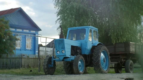 Rustic Tractor with Wagon standing near the House Stock Footage 60962204