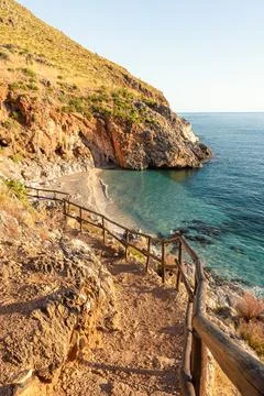 Rustic trail leading to a hidden beach on the Mediterranean coast Stock Photos