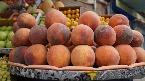 Rustic tray stacked with orange red peaches Stock Photos