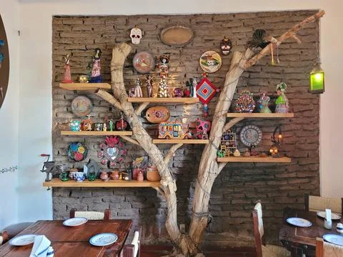 Rustic Tree Branch Shelving Displaying Mexican Folk Art Stock Photos