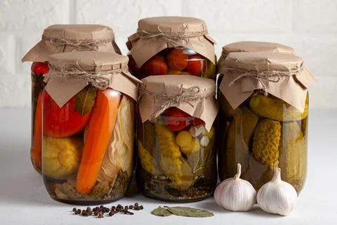 Rustic vegetable pickling in glass jars Stock Photos