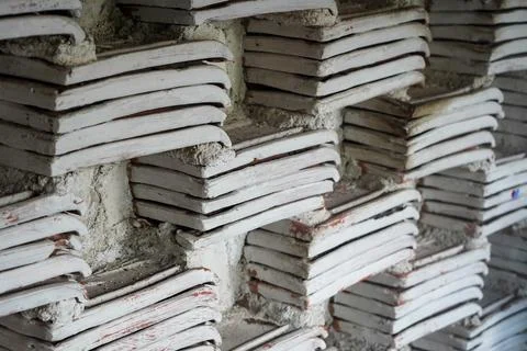 Rustic wall background made from stacked traditional clay roof tiles 写真素材