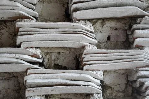 Rustic wall background made from stacked traditional clay roof tiles Fotos Stock