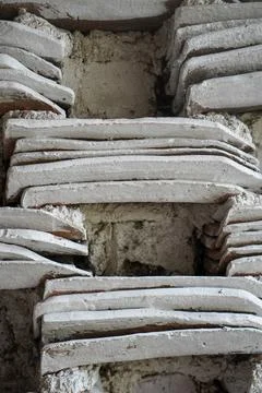 Rustic wall background made from stacked traditional clay roof tiles Stock Photos