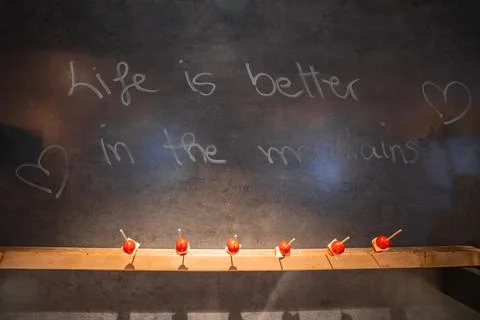 Rustic Wall with Handwritten Phrase and Candied Apples Display Stock Photos
