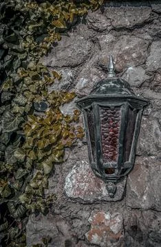 Rustic wall with a lantern Stock Photos