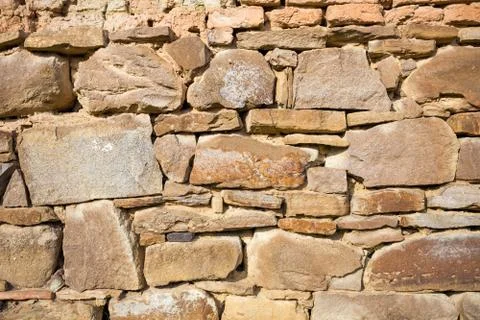 Rustic wall with layers of different shapes of rough sandstones Stock Photos