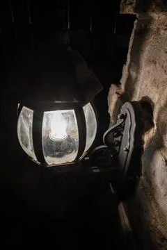 Rustic wall sconce with wrought iron details and light bulbs for a vintage lo Stock Photos