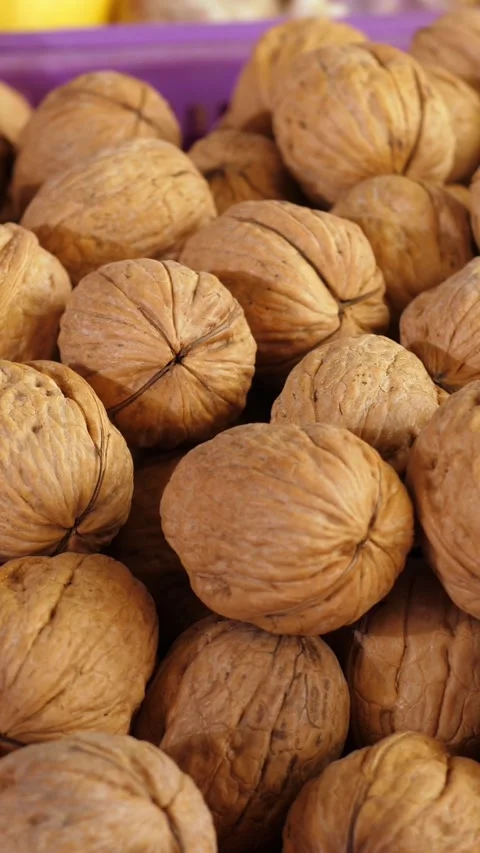 Rustic Walnuts Displayed at a Bustling Italian Traditional Street Market Stock Footage 335695359