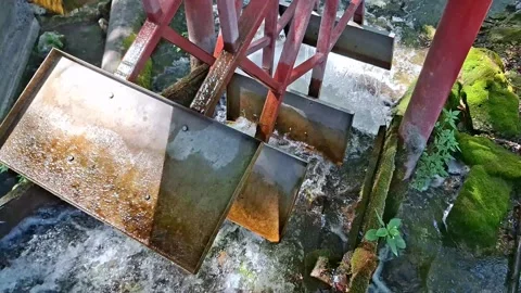 Rustic Water Mill Wheel Powered by Flowing Water in a Peaceful Park Setting Stock Footage 345199246