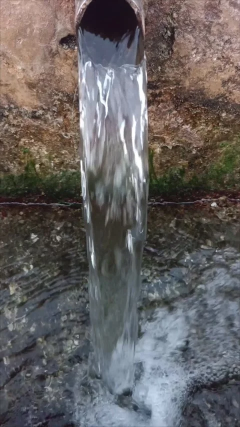 Rustic Water Spring Pipe Flowing with Clear Fresh Stream Stock Footage 338336548