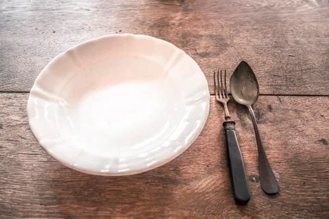 Rustic weathered tableware on wooden table Stock Photos
