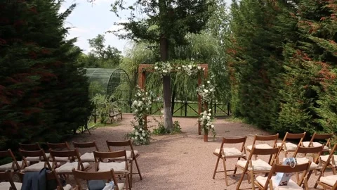 Rustic wedding arch for an exit ceremony decorated with white and flowers. Stock Footage 157670956