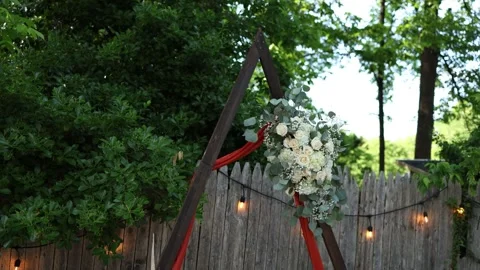 Rustic wedding arch with flowers and lights Stock Footage 337723402