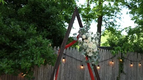 Rustic wedding arch with flowers and lights Stock Footage 337723533