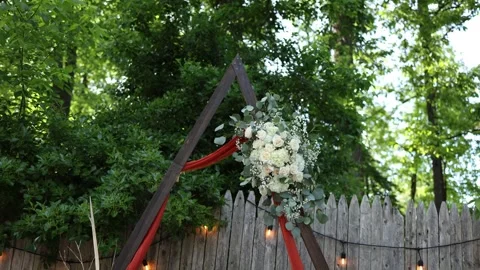 Rustic wedding arch with flowers in garden Stock Footage 337723834