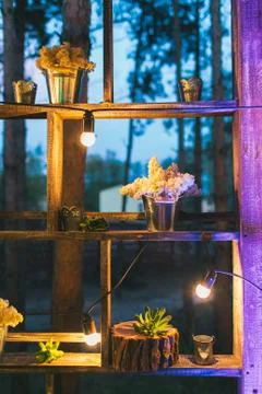 Rustic wedding decor, shelf stand with lilac arrangements and su 写真素材