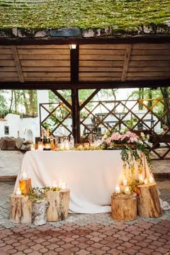 Rustic wedding decor on a timber background. Main table setting for bride and Stock Photos