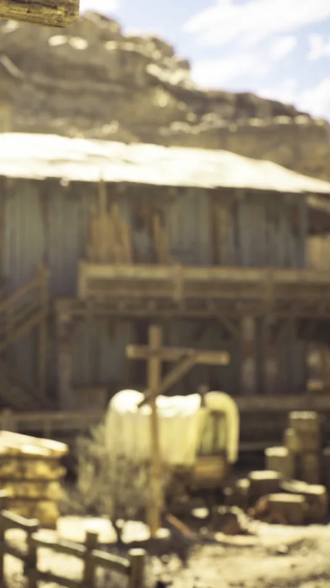 Rustic western scene with an old barn and wooden wagon under a bright sky Stock Footage 331803886