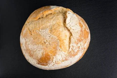 Rustic wheat bread  on Black background. Fotos Stock