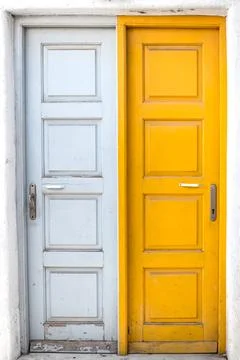 Rustic white and yellow doors of Greek island Stock Photos