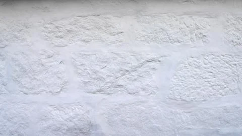 Rustic white wall texture and background. Uneven, imperfect old bricks with Stock Photos