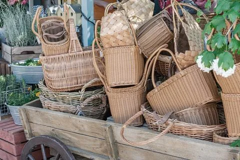 Rustic Wicker Baskets on Weathered Wood Cart at Outdoor Market 스톡 사진