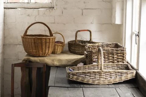 Rustic Wicker Baskets on a Wooden Table in Cozy Sunlit Room Stock-Fotos