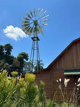 Rustic Windmill by Wooden Barn Stock Photos