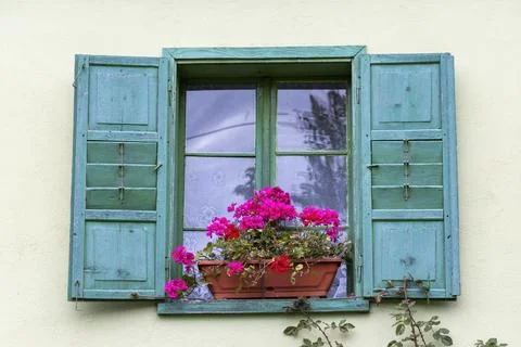 A rustic window decorated with flowers Stock Photos