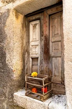 Rustic window with flower cage display Stock Photos
