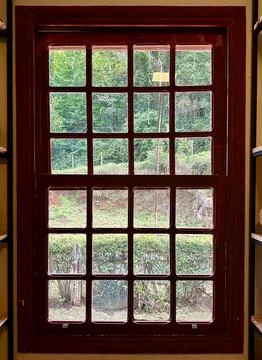 Rustic window view with lush vegetation Stock Photos