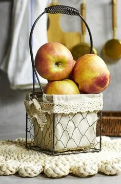 Rustic Wire Basket With Fresh Apples In Linen Lined, Cozy Kitchen Decor Stock Photos
