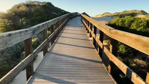 Rustic Wood Beach Boardwalk Through Sand Dunes. Oso Flaco Lake, CA Stock Footage 234588754