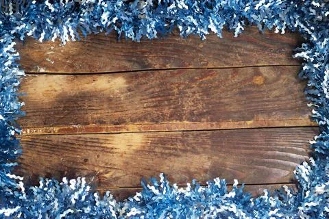 Rustic Wooden Background Framed With Blue Tinsel For Holiday, Winter and Christm Stock Photos