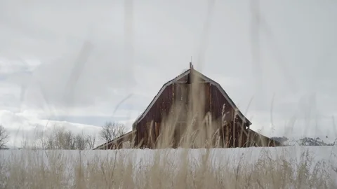 Rustic wooden barn on a snow covered landscape Stock Footage 113235389