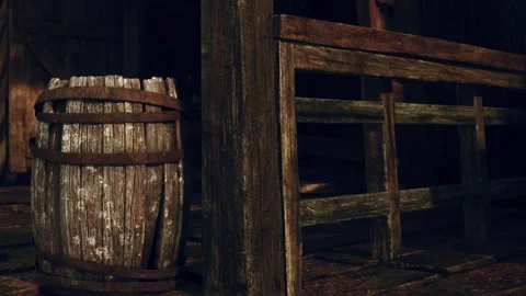 Rustic Wooden Barrel Rests Beside an Old Weathered Fence in a Barn Stock Footage 344820919