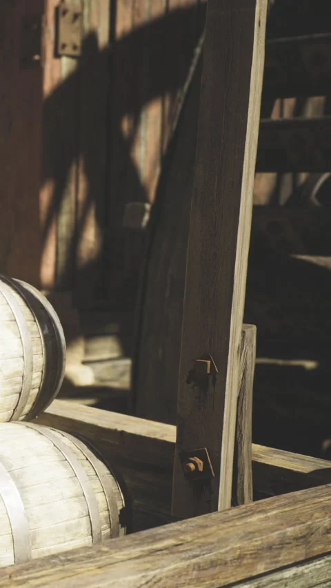 Rustic wooden barrels resting in a sunlit old warehouse full of charm Stock Footage 341400924
