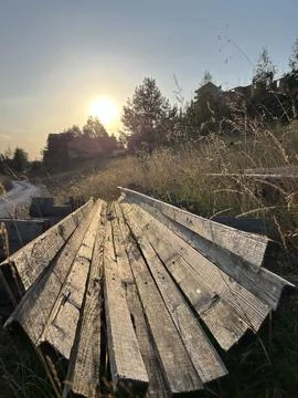 Rustic Wooden Beams Structure in Tall Grass at Sunset Zlatibor Serbia Stock-Fotos