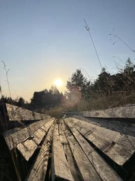 Rustic Wooden Beams Structure in Tall Grass at Sunset Zlatibor Serbia Stock Photos