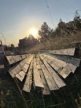Rustic Wooden Beams Structure in Tall Grass at Sunset Zlatibor Serbia Stock Photos
