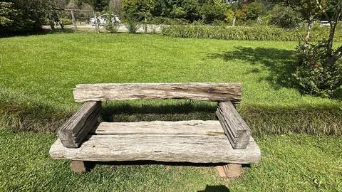Rustic wooden bench on grass Stock Photos
