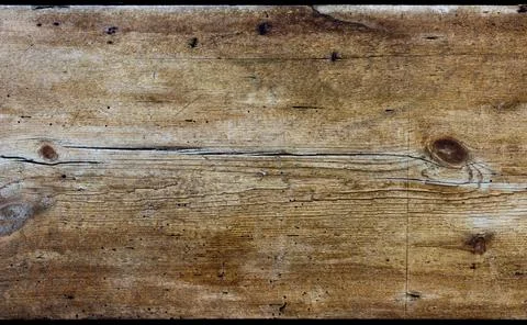 A rustic wooden board texture background with shades of yellow, gold and brown Stock Photos