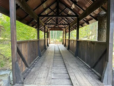 Rustic wooden bridge in the forest Stock Photos