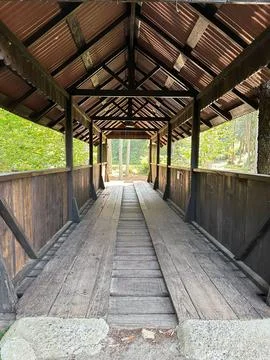 Rustic wooden bridge in a forest setting Stock Photos