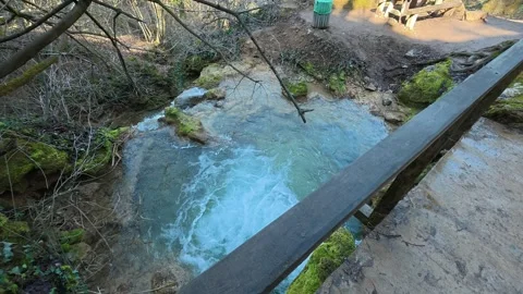 Rustic wooden bridge spans clear, rushing water. Mount Ozren 스톡 동영상 330551686