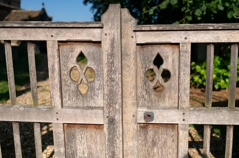 Rustic wooden gate with cutouts. Stock Photos