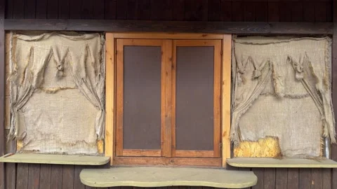 Rustic wooden house facade with burlap curtains and double glass doors Stock-Footage 337302431