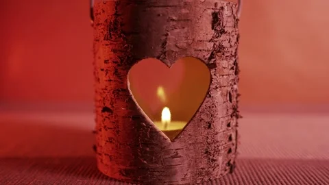 Rustic Wooden Lantern with Heart-Shaped Cutout and Glowing Candle 動画素材 338185924