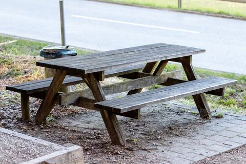 Rustic wooden picnic table at roadside rest area Stock Photos